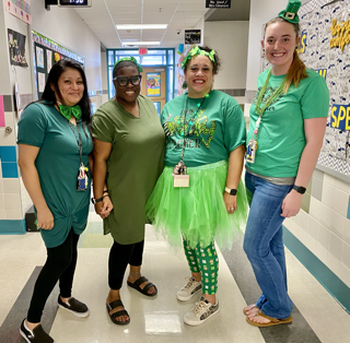 photo of 4 staff members wearing green and feeling lucky.